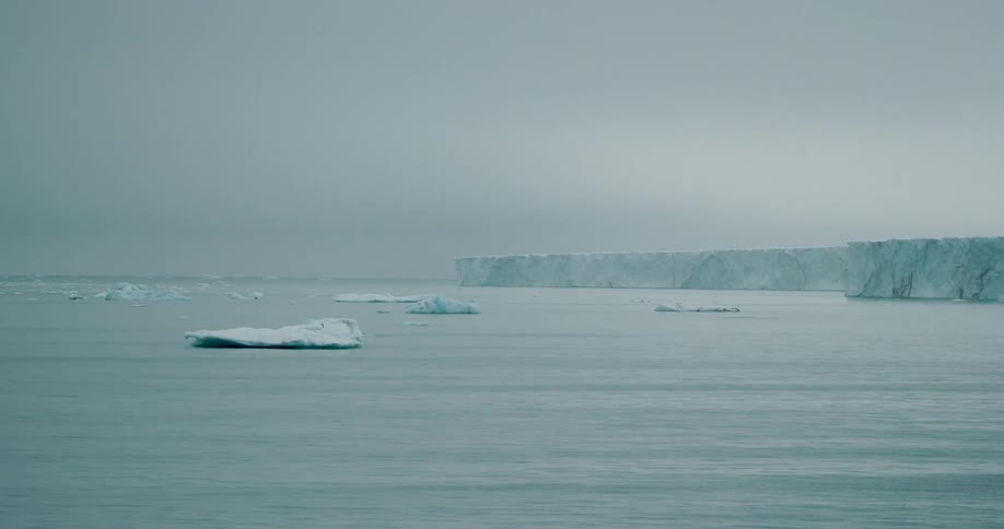 Large chunks of ice float off the coast of a glacier