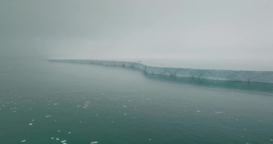 Glacier and pieces of ice floating on the arctic water