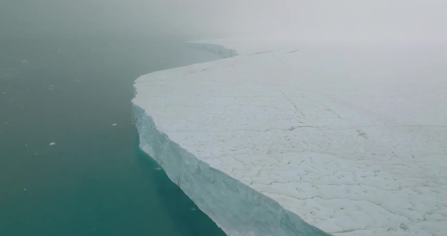 Glacier and pieces of ice floating on the arctic water