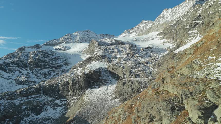 Light snow cover on the rough terrain of mountains
