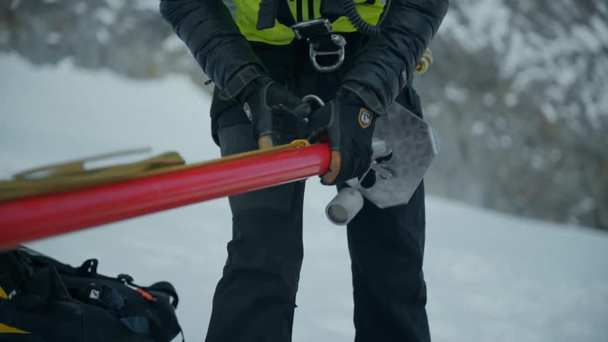 Man setting up equipment on a snow covered mountain