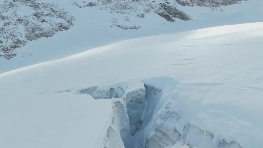 Deep crevasse on a snow covered mountain