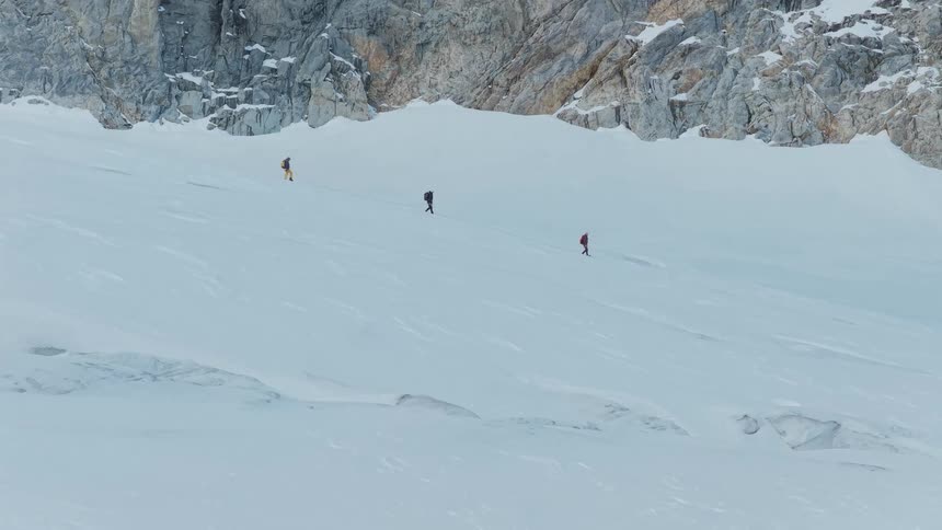 A group of people hiking on a snowy mountain