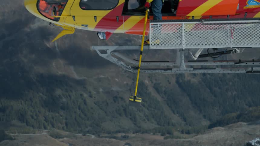 A man looking out of a helicopter