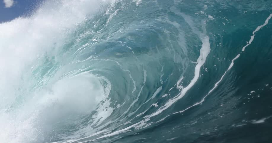 Large ocean wave curls and releases foam as it breaks