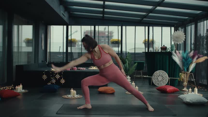 A woman doing yoga and stretching in a studio
