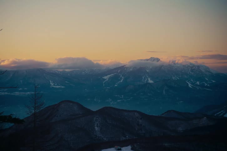 Mountains across the landscape with snow on the rough terrain