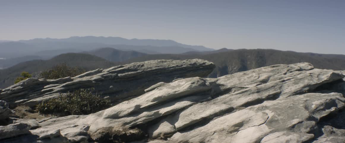 Large rock slabs in wilderness on sunny day