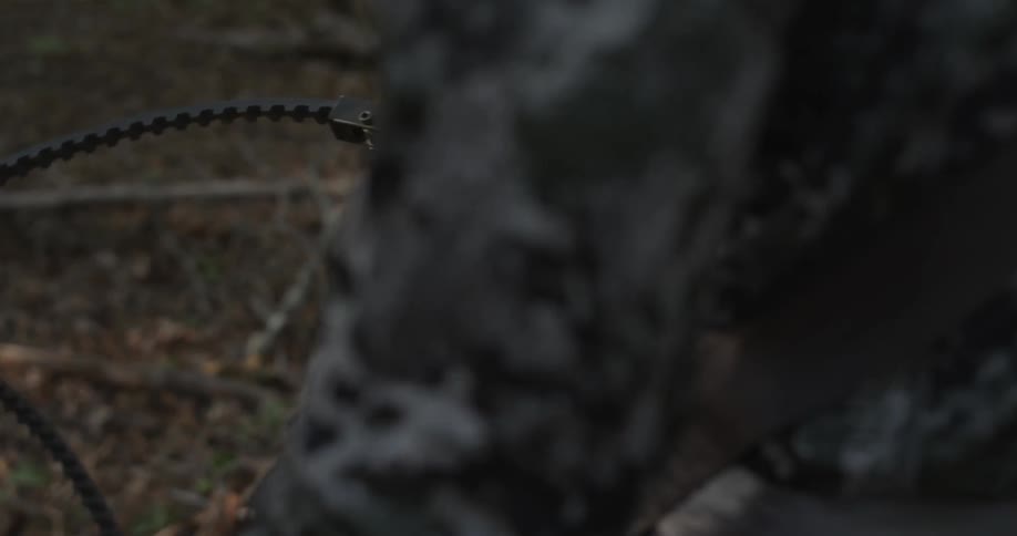 A man is setting a trap in the woods