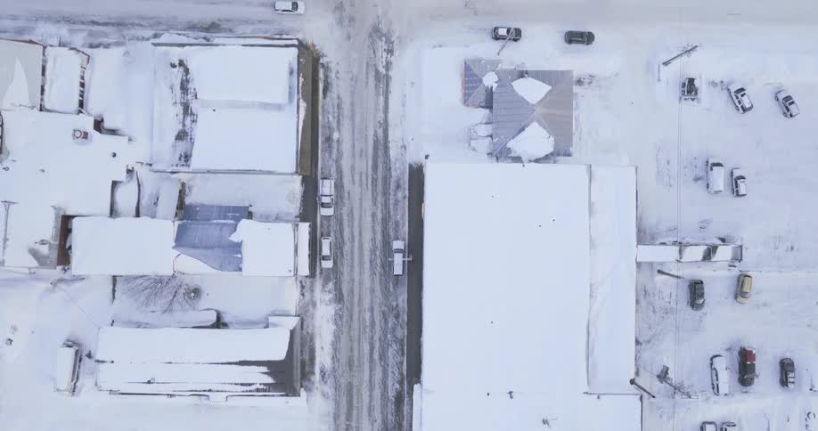 Houses and cars on a suburban neighborhood covered in snow outdoors during day time