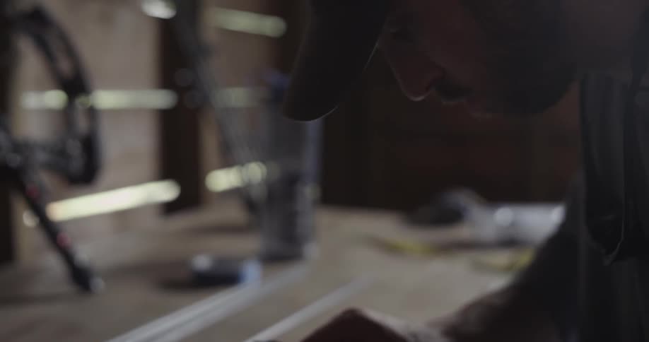 A man is working on something on his workbench