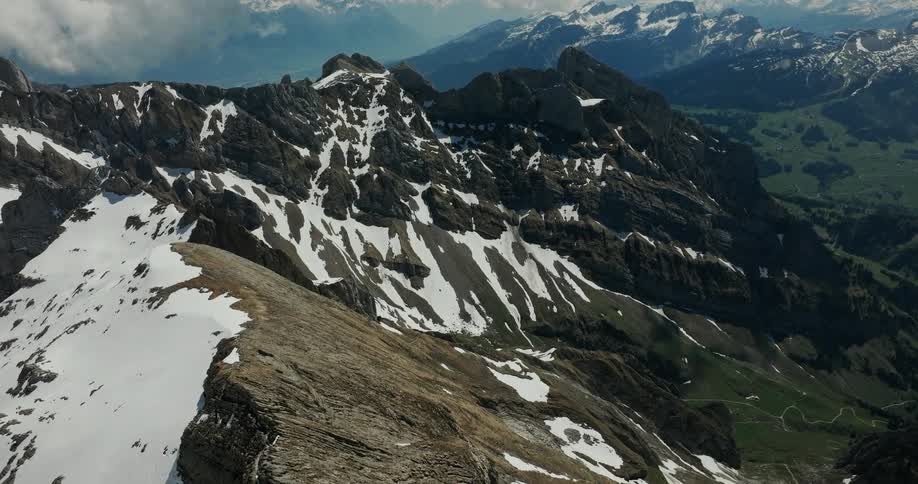 An aerial view of a mountain with some snow on it