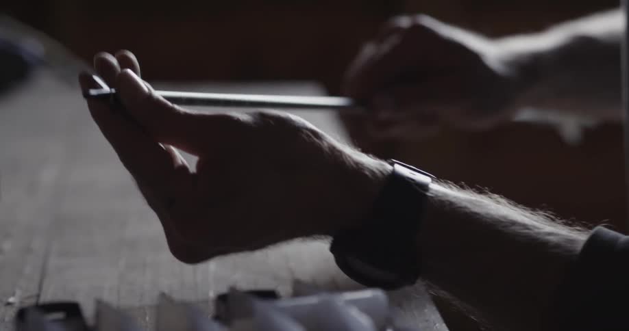 A person turns an arrow in their hand