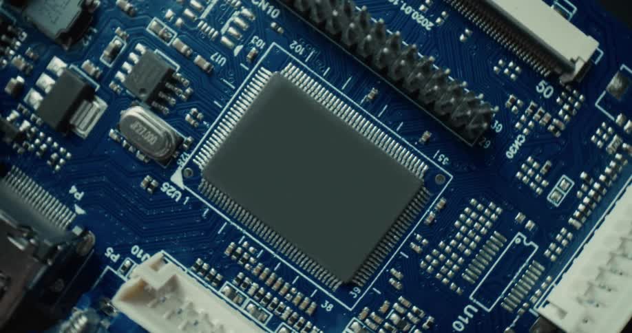 Microchip mounted on a printed circuit board with visible traces and connectors