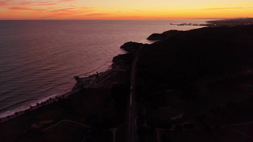 An aerial view of a sunset over a coast