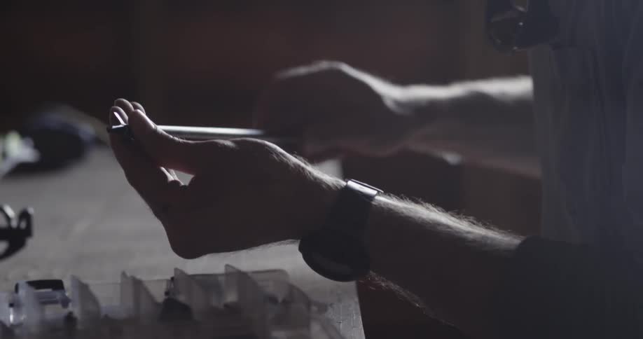 A man twists a stick in his hands