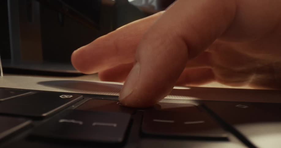 A close up of a person hitting a key on a keyboard