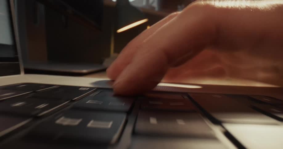 A person is typing on a laptop then abruptly stops after hitting enter
