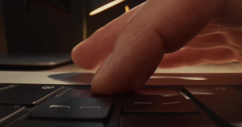 Fingers typing on the keyboard of a laptop computer