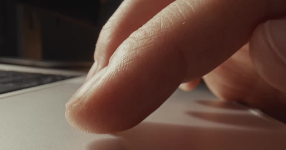 A person using a touch pad on a laptop