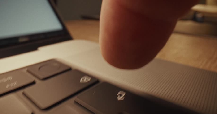A finger types on a keyboard