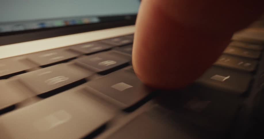 A close up of someone typing on a keyboard