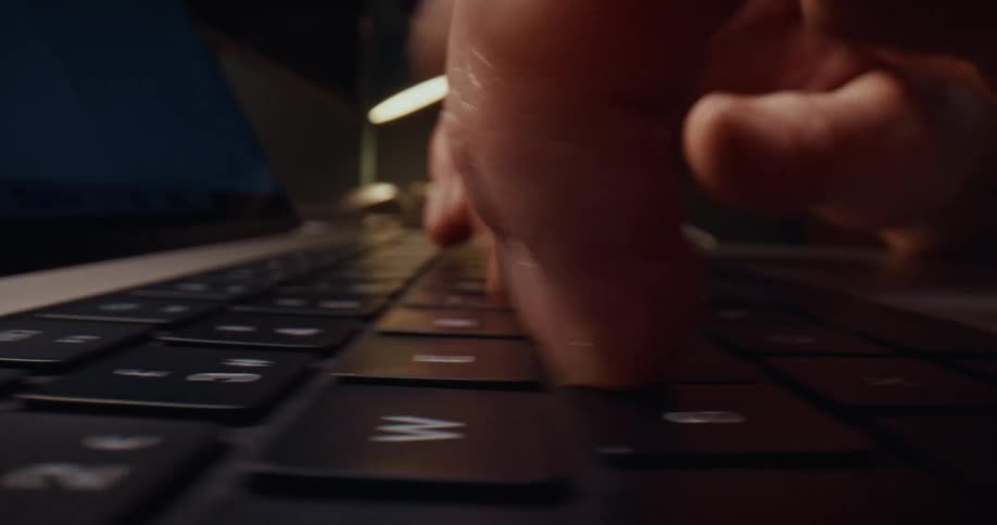 Fingers typing on the keyboard of a laptop computer