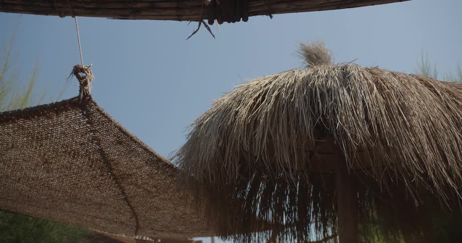 A view of a hut and straw outdoors