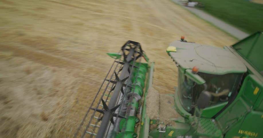 Agricultural harvester operating seen from above during harvesting