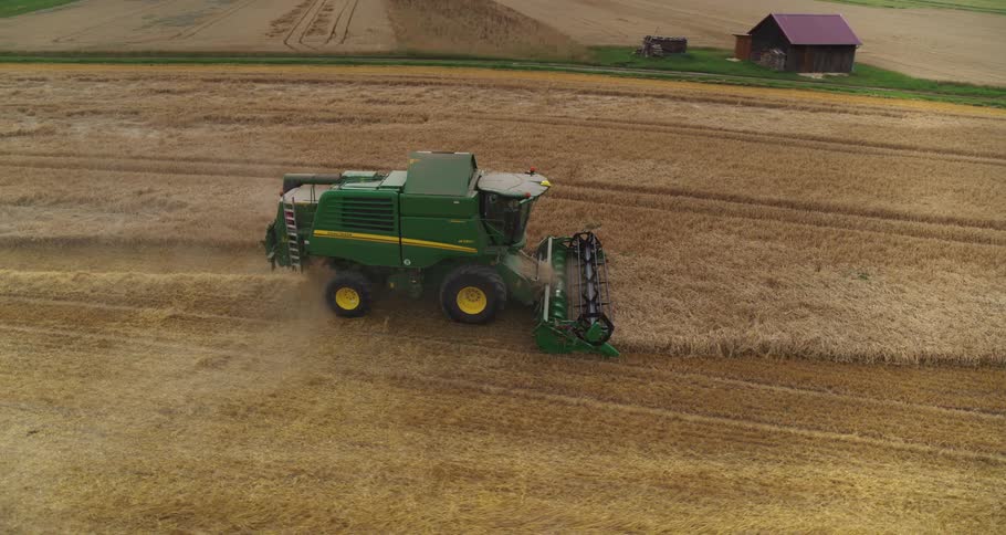 Agricultural harvester operating in a grain field from an aerial view