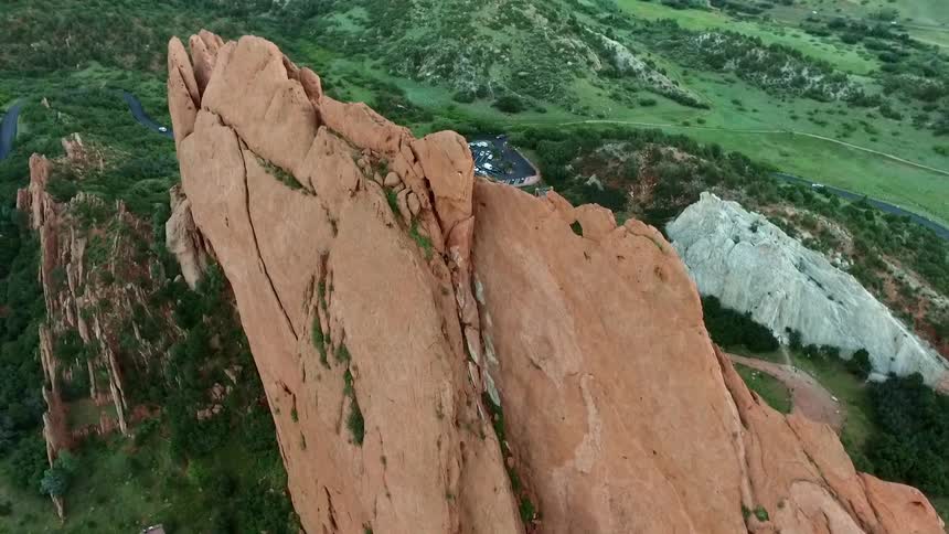 Aerial view of large rock formations and a parking lot