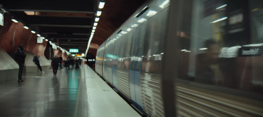 A subway train leaving a station