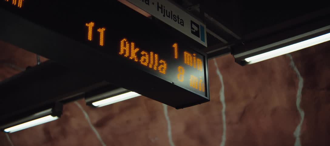 A terminal with a digital display board showing various timers and ride information