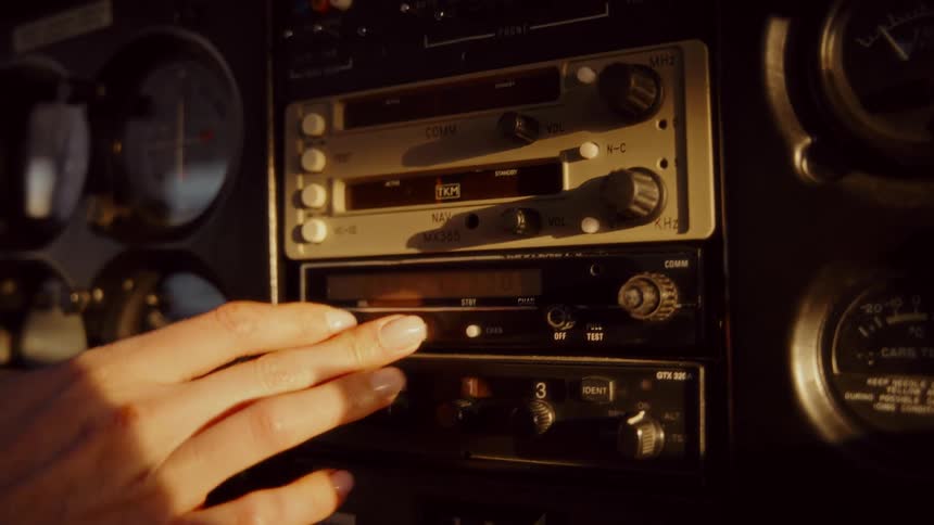 Hand adjusting an aircraft instrument panel with illuminated analog controls