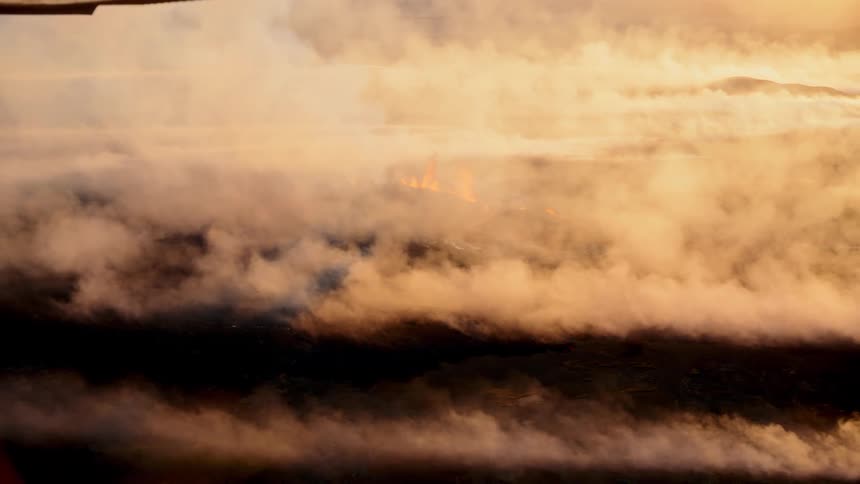 An aerial view of the top of clouds