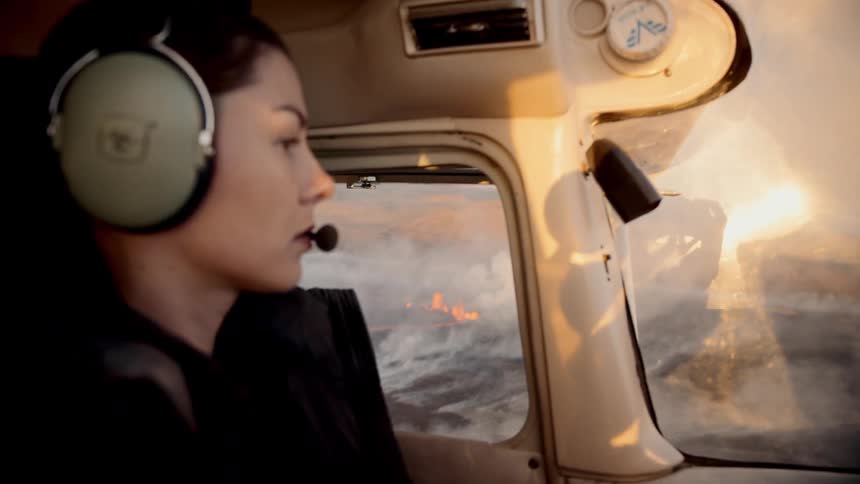 A woman flying a plane on a sunny day