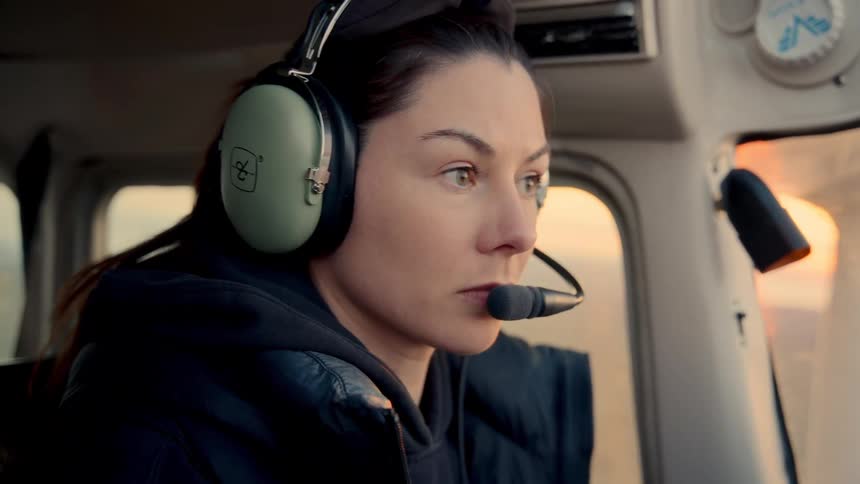 The woman is concentrating as she flies the plane