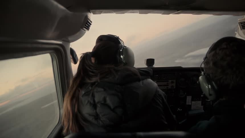The woman is flying the airplane