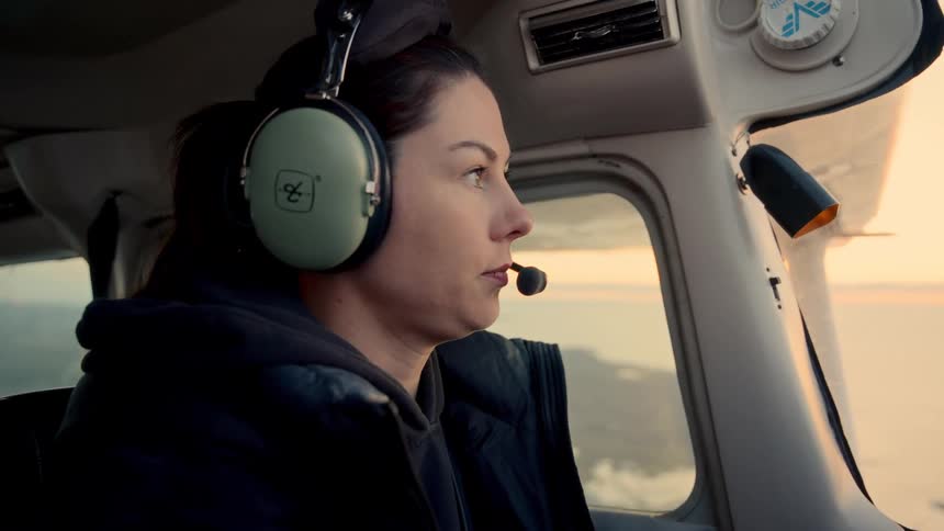 Woman in the cockpit is flying an airplane