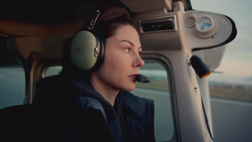 Woman focused on piloting an airplane