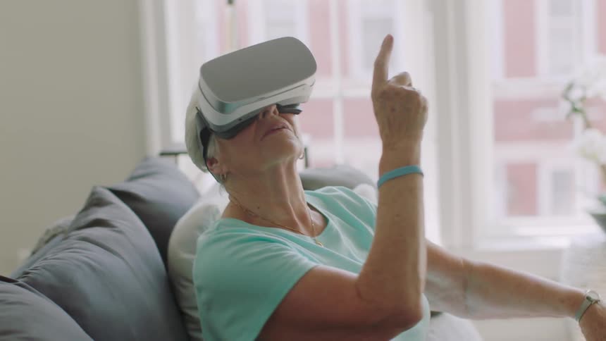A woman wearing vr glasses looks up and points