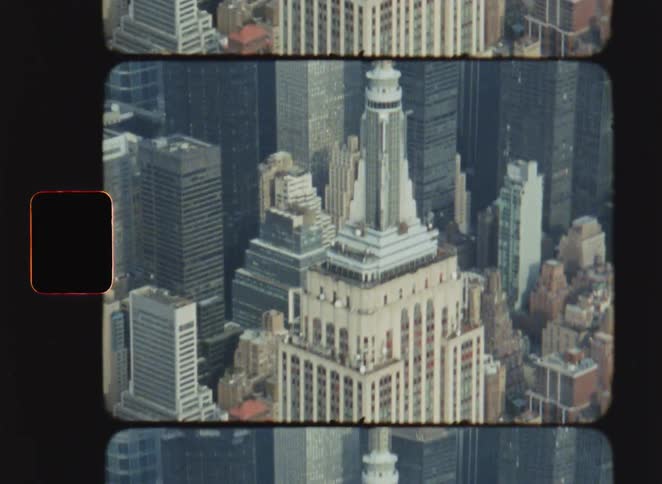 Empire state building stands out among skyscrapers in new york seen from above in film frame