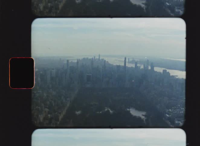 Persons legs suspended in an elevated environment with a panoramic view of a metropolis
