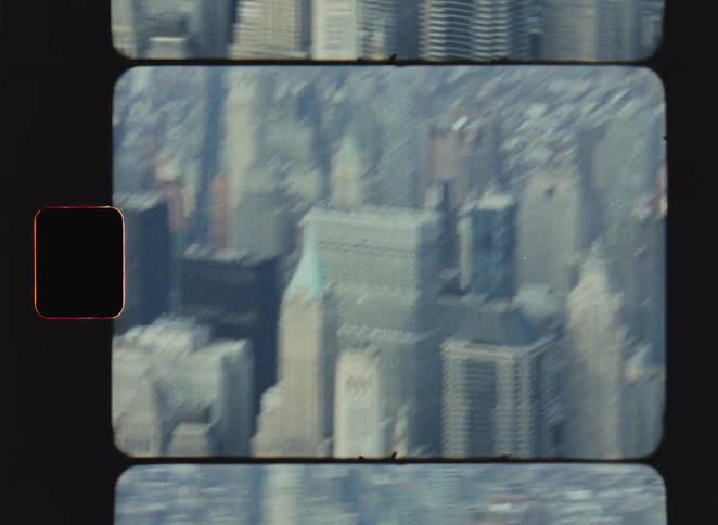 A dense city skyline stretches across a hazy horizon
