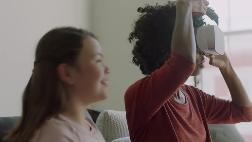 A girl puts on a vr headset