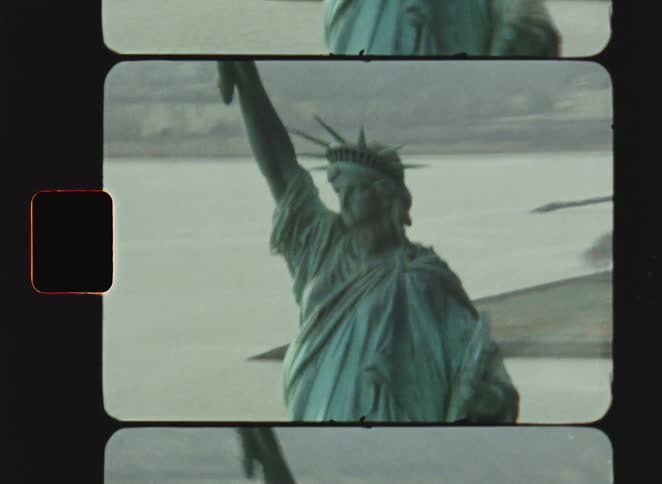 Statue of liberty seen from above with island and mainland in the background