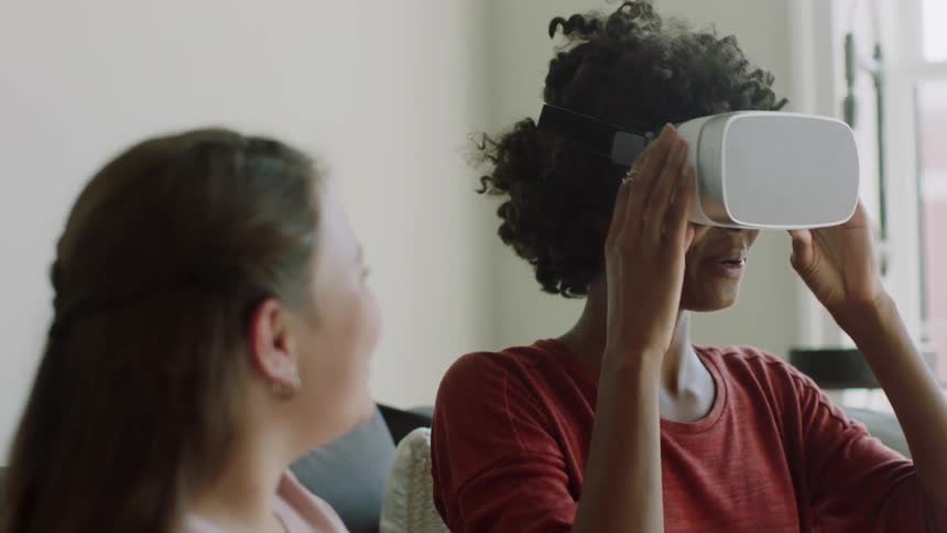 A woman plays with a vr headset