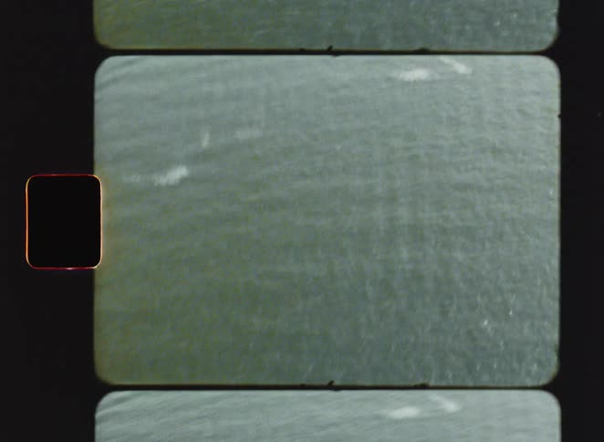 Water surface with a grainy texture and subtle variations of light