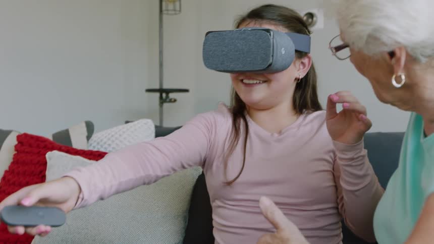A girl smiles as she uses a vr headset
