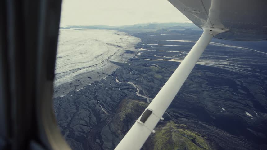Through the plane window the landscape is visible